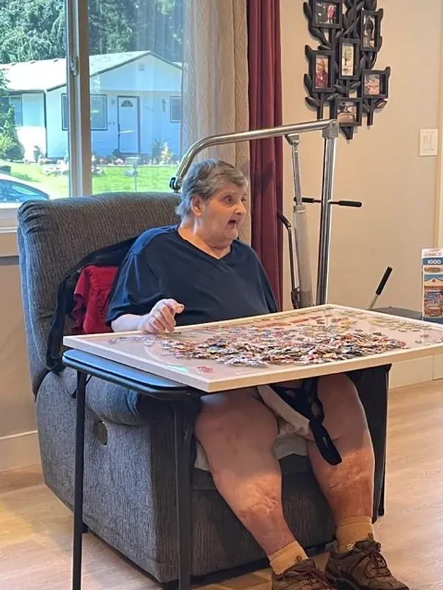A resident works on a jigsaw puzzle in the living room.